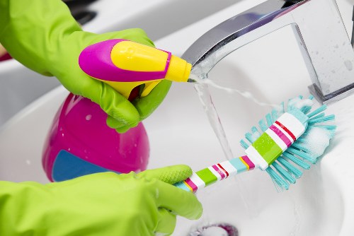 Spot cleaning a rug stain carefully with blotting technique