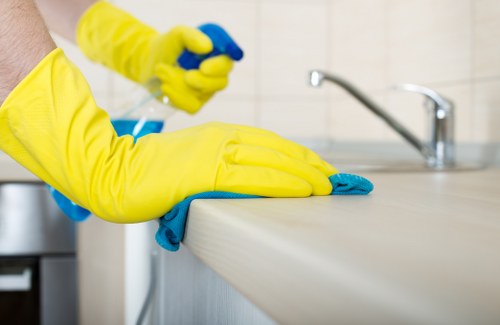 Office cleaning supplies and disinfecting tools on a cart